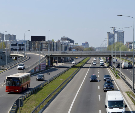 City view with wide avenue and cars driving on both sides