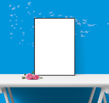 Empty desk with a frame on a blue background with birds